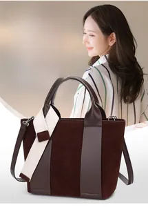 Detail shot of a dark brown large tote bag with textured faux suede and leather finish