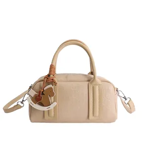 Beige Boston bag in premium faux leather with rocking horse charm and top handles
