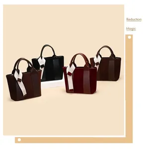 Close-up of suede and leather tote bags with ribbon handles in four different colors