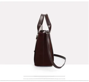 Macro view of stitching details on dark brown suede and smooth leather shoulder bag
