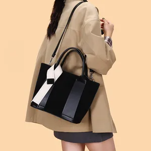Retro black matte leather tote bag with decorative silk ribbon and long shoulder strap