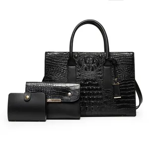 Three-piece black crocodile pattern handbag set with tote, clutch and wallet