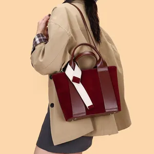 Vintage burgundy matte leather tote bag with stylish white fabric ribbon decoration