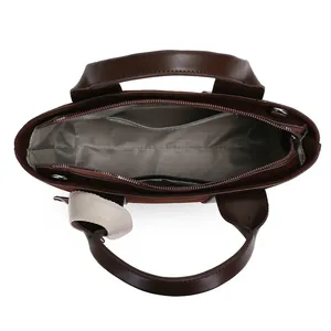 Deep brown minimalist faux leather tote bag with gray herringbone lining and interior pockets