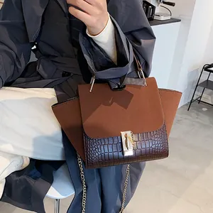 Brown frosted leather wing bag with croc-embossed texture and gold chain strap