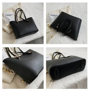 Detailed views of a large black matte tote bag with gold metal hardware and slim straps