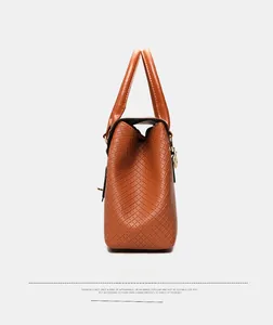 Close-up of caramel brown tote bag featuring intricate lattice woven texture on the side
