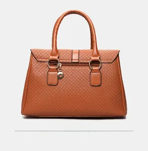 Detail view of the back of a brown quilted leather handbag with a functional zipper pocket