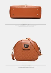 Detail of brown crossbody bag with cat lock, diamond quilting, and metal bottom studs