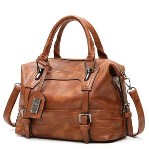Vintage brown PU leather Boston handbag with adjustable shoulder strap and metal tag