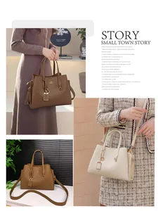 Détail du sac cabas en cuir avec trois compartiments, bandoulière et logo doré chic