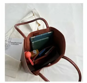 Internal capacity of brown tote bag showing tablet, umbrella, and spacious structure