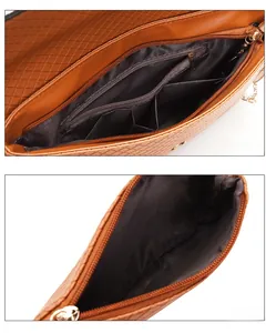 Detailed interior of brown quilted chain bag and clutch with zipper pocket