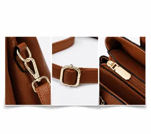 Detailed macro view of gold metal buckles and zipper on brown lychee leather handbag