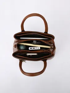 Detailed top view of brown leather tote bag with multiple compartments for organization
