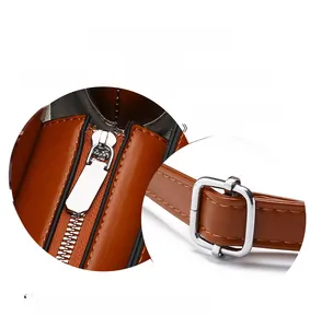 Detailed macro view of silver metal zipper and hardware on brown leather mini wallet