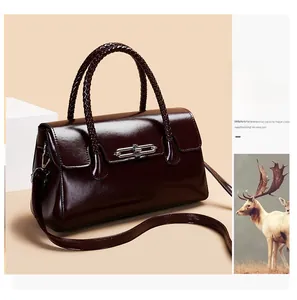 Deep burgundy leather handbag featuring woven handles and silver chain metal twist lock
