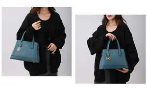 Close-up of teal leather tote bag with metal floral charm and branding detail