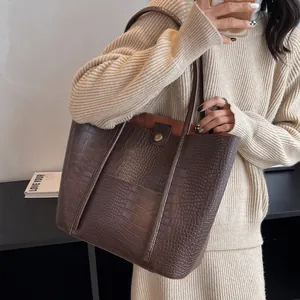 Large brown crocodile pattern tote bag with dual shoulder straps for daily commuting