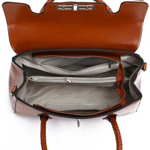 Brown leather crossbody bag with spacious interior compartments and woven handle