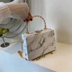 Fashionable marble pattern box clutch with golden wave handle and elegant metal chain strap