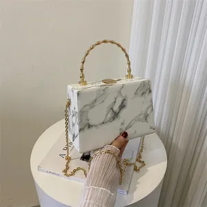 Elegant marble pattern box handbag with gold wave handle and metal chain strap