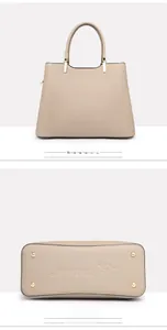 Detail view showing the reinforced bottom rivets and back of this khaki top-handle bag