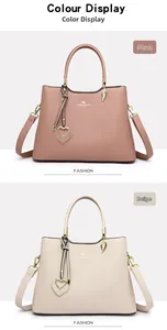 Detailed view of pink and beige crossbody bags with textured leather and leaf charms