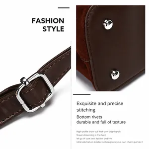 Detailed close-up of dark brown matte leather stitching and silver bottom rivets