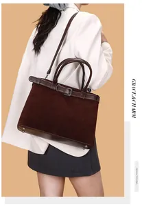 Deep brown matte tote bag shown on model featuring decorative belt straps and a side view