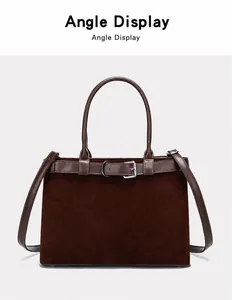 Macro detail of dark brown matte suede tote bag with decorative belt buckle and handle