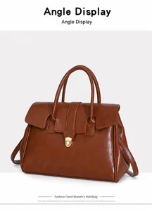 Detail view of brown leather briefcase tote with vintage gold clasp and matte texture