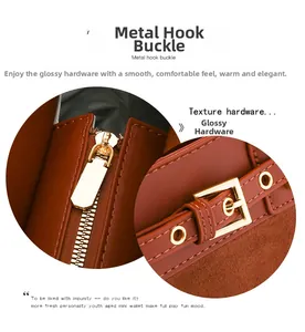 Detail of golden metal zipper and buckle on a brown leather vintage tote bag