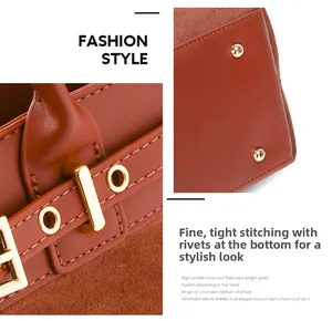 Detail of fine contrast stitching and protective metal rivets on the suede tote bag