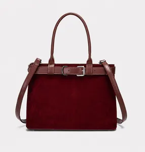 Detailed view of burgundy frosted leather tote with silver buckle strap and long handles