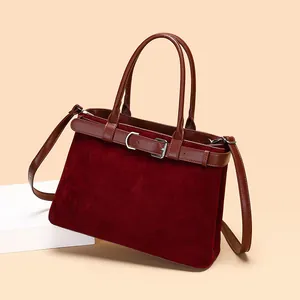 Large burgundy matte tote bag with decorative belt detail and adjustable shoulder strap