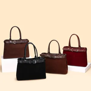 Suede tote bags in dark coffee and burgundy with elegant belt buckle decor on display