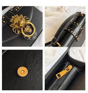 Detail view of lion head metal buckle with golden rivets and white contrast stitching on leather