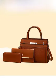 Detailed view of tan crocodile-patterned bag set with metallic twist lock and hardware