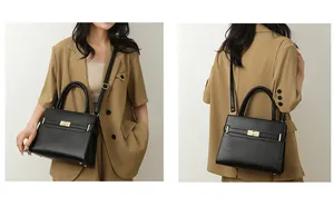Détail d'un sac à main noir en cuir grainé avec fermoir tournant doré et double poignée