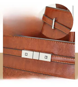 Detailed close-up of brown textured leather hand bag with silver metallic buckle lock