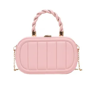 Pink quilted box-shaped shoulder bag with twisted handle and gold chain strap