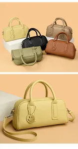 Detail of soft litchi grain leather tote bags in multiple colors with smiley face charm
