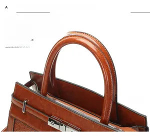 Detailed close-up of brown faux leather handbag with silver lock and handles