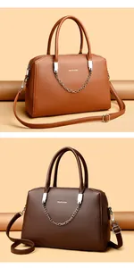 Detail of faux leather handbags with metal chain and adjustable strap in two shades