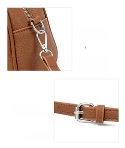 Close-up of brown pebbled leather bag with detachable silver hook and adjustable strap