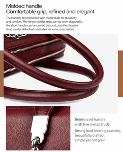 Details einer weinroten Handtasche aus Kieselleder mit silbernen Metallteilen und Griffen