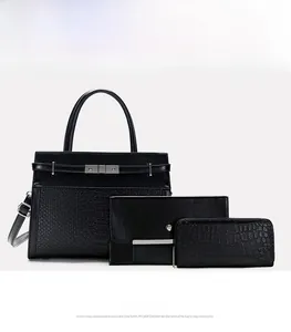 Three-piece black set featuring crocodile-embossed tote bag, clutch, and small coin purse