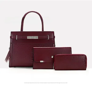 Three-piece reddish brown handbag set with crocodile pattern and smooth leather finish