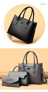 Détail d'un ensemble de trois sacs de luxe gris avec une finition texturée de qualité